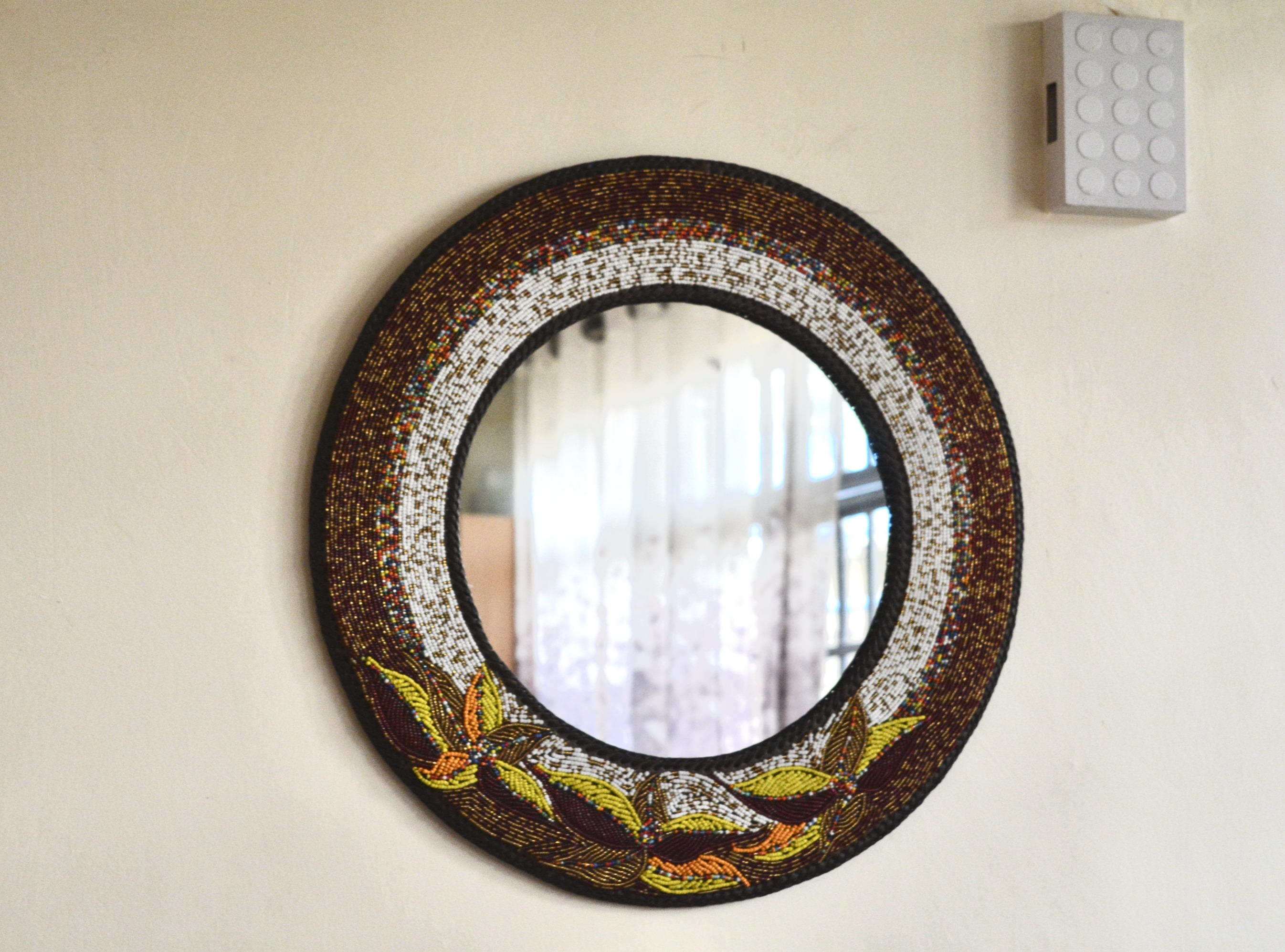 Mixed colored beaded mirror with flower